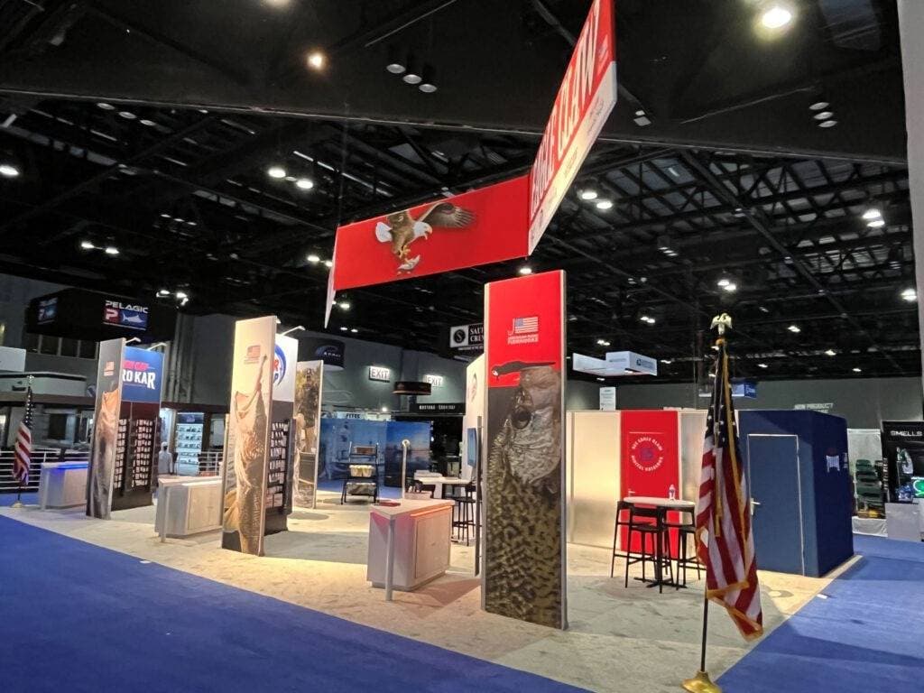 custom 30x50 trade show exhibit booth with free standing graphics, counters and hanging banner sign