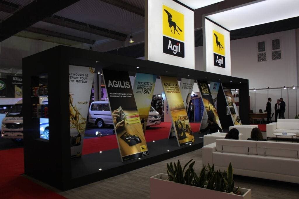 Agil 20x30ft trade show exhibit booth with furniture and graphics.